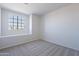 A well-lit bedroom features neutral carpeting, a double hung window, and light walls at 19437 N 43Rd Dr, Glendale, AZ 85308