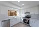 Bright kitchen with white cabinets, modern appliances, and a view of the backyard at 19437 N 43Rd Dr, Glendale, AZ 85308