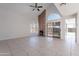 Bright living room featuring a brick fireplace, tile floors, and access to the outdoor patio at 19437 N 43Rd Dr, Glendale, AZ 85308