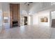 Spacious living room with a brick fireplace, tile flooring, and large windows for natural light at 19437 N 43Rd Dr, Glendale, AZ 85308
