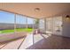 Enclosed patio with tile floor and view of a green backyard at 19437 N 43Rd Dr, Glendale, AZ 85308