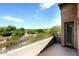 Balcony with iron railing overlooking lush desert landscape and golf course views at 19475 N Grayhawk Dr # 1018, Scottsdale, AZ 85255