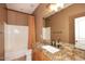 Bathroom featuring a granite countertop, a well-lit mirror, and neutral wall tones at 19475 N Grayhawk Dr # 1018, Scottsdale, AZ 85255