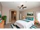 Bedroom with a ceiling fan, a comfortable bed, and an attached bathroom, and neutral walls at 19475 N Grayhawk Dr # 1018, Scottsdale, AZ 85255