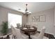 Elegant dining room featuring a chandelier and a wood table set for six, creating a welcoming space at 19475 N Grayhawk Dr # 1018, Scottsdale, AZ 85255