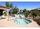 Relaxing hot tub surrounded by lush landscaping and seating, perfect for unwinding after a long day at 19475 N Grayhawk Dr # 1018, Scottsdale, AZ 85255