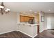 Kitchen area showcases an open concept with counter seating, warm cabinetry, and modern backsplash at 19475 N Grayhawk Dr # 1018, Scottsdale, AZ 85255