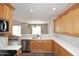 Open kitchen featuring white countertops, a stainless steel dishwasher, and view into the dining room at 19475 N Grayhawk Dr # 1018, Scottsdale, AZ 85255
