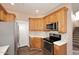 Cozy kitchen with stainless steel appliances, light wooden cabinets, and mosaic backsplash at 19475 N Grayhawk Dr # 1018, Scottsdale, AZ 85255