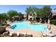 Inviting outdoor pool surrounded by lush landscaping and lounge chairs for ultimate relaxation at 19475 N Grayhawk Dr # 1018, Scottsdale, AZ 85255