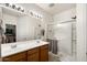 Bathroom featuring a double sink vanity and a glass-enclosed shower at 21244 E Creekside Dr, Queen Creek, AZ 85142