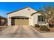 Beige stucco home with an attached 2 car garage, tile roof, and a well-maintained landscape at 21244 E Creekside Dr, Queen Creek, AZ 85142