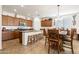 Open kitchen with an island featuring granite countertops, ample wood cabinetry, and stainless appliances at 21244 E Creekside Dr, Queen Creek, AZ 85142