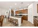 Bright kitchen with ample cabinetry, granite countertops, and a central island with seating at 21244 E Creekside Dr, Queen Creek, AZ 85142