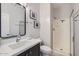 Modern bathroom with a single vanity, a walk-in shower with glass door, neutral decor, and tile flooring at 22181 N 78Th St, Scottsdale, AZ 85255