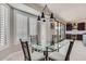 Breakfast nook features large windows with shutters and a modern glass table at 22181 N 78Th St, Scottsdale, AZ 85255