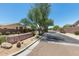 View of a gated community entrance, landscaped with desert plants and a large stone sign at 22181 N 78Th St, Scottsdale, AZ 85255
