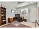 Functional home office with tile floors, a spacious desk, a window with shutter-style blinds, and a ceiling fan at 22181 N 78Th St, Scottsdale, AZ 85255