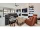 Open concept living room with fireplace, built-in shelving, and stylish furniture at 22181 N 78Th St, Scottsdale, AZ 85255