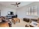 Spacious living room featuring a large flat screen TV, comfortable seating, and natural lighting at 22181 N 78Th St, Scottsdale, AZ 85255