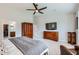 Spacious main bedroom featuring a ceiling fan, wood furniture, and a walk-in closet for ample storage at 22181 N 78Th St, Scottsdale, AZ 85255