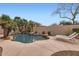 Inviting backyard pool surrounded by mature palm trees and desert landscaping at 22181 N 78Th St, Scottsdale, AZ 85255