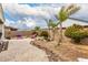 Outdoor backyard with stone pavers, gravel, stone border, palm trees and a rock Buddha at 22452 E Calle De Flores --, Queen Creek, AZ 85142