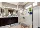 Bright bathroom with dual sinks, vanity, glass shower and natural light at 22452 E Calle De Flores --, Queen Creek, AZ 85142