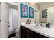 Clean bathroom features a single vanity, stylish mirror, and shower behind a curtain at 22452 E Calle De Flores --, Queen Creek, AZ 85142