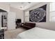 Teen bedroom has dark brown futon, wall art, window and gray carpet at 22452 E Calle De Flores --, Queen Creek, AZ 85142