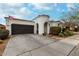 Inviting single-story home showcasing desert landscaping, two-car garage, and a quaint turret entrance at 22452 E Calle De Flores --, Queen Creek, AZ 85142