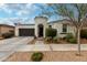 Charming home featuring a turret entryway, desert landscaping, and a two-car garage at 22452 E Calle De Flores --, Queen Creek, AZ 85142