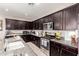Kitchen featuring ample dark wood cabinetry, granite countertops, and stainless steel appliances at 22452 E Calle De Flores --, Queen Creek, AZ 85142