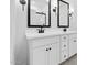 Elegant bathroom featuring dual sinks, black fixtures and modern lighting at 23435 W Albeniz Pl, Buckeye, AZ 85326