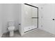 Modern bathroom showcasing a sleek glass-enclosed shower and tiled floor at 23435 W Albeniz Pl, Buckeye, AZ 85326
