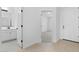 Bright hallway featuring wood floors, white walls, with the bathroom and bedroom doors on either side of the entryway at 23435 W Albeniz Pl, Buckeye, AZ 85326