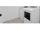 Modern laundry room featuring white washer and dryer units at 23435 W Albeniz Pl, Buckeye, AZ 85326