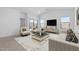 Bright living room featuring modern furniture, neutral tones, and a seamless indoor-outdoor flow at 23435 W Albeniz Pl, Buckeye, AZ 85326