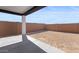 Covered patio area overlooks the backyard with privacy wall at 23435 W Albeniz Pl, Buckeye, AZ 85326