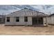 The backyard is under construction featuring sliding glass doors and space for outdoor entertaining at 24080 W Bowker St, Buckeye, AZ 85326