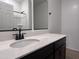 Bathroom featuring dark cabinets, white countertops and black hardware that gives the room a modern, high-contrast feel at 24080 W Bowker St, Buckeye, AZ 85326