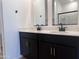 Bathroom features a dual sink vanity with dark cabinets and quartz countertops at 24080 W Bowker St, Buckeye, AZ 85326