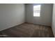 Bright bedroom featuring neutral carpet, a large window for natural light and white walls, creating a peaceful space at 24080 W Bowker St, Buckeye, AZ 85326