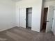 Bright bedroom featuring neutral carpet, closet, and white walls, creating a serene and inviting atmosphere at 24080 W Bowker St, Buckeye, AZ 85326