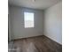 Cozy bedroom with tile flooring, a window, and neutral paint, offering a peaceful retreat at 24080 W Bowker St, Buckeye, AZ 85326
