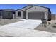 Charming single-story home featuring a neutral stucco exterior, desert landscaping and a two-car garage at 24080 W Bowker St, Buckeye, AZ 85326