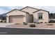 Inviting single-story home showcasing neutral stucco, a two-car garage, and desert landscaping at 24080 W Bowker St, Buckeye, AZ 85326