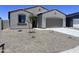Charming single-story home featuring a neutral stucco exterior, desert landscaping and a two-car garage at 24080 W Bowker St, Buckeye, AZ 85326