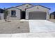 Charming single-story home featuring a neutral stucco exterior, desert landscaping and a two-car garage at 24080 W Bowker St, Buckeye, AZ 85326