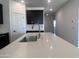 Open-concept kitchen with island sink, white countertops, dark cabinets, and recessed lighting at 24080 W Bowker St, Buckeye, AZ 85326